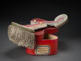 a small red box with a pair of shoes inside of it