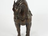 bronze figurine of a bull on a white background