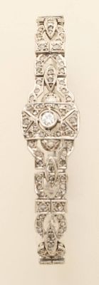 a silver watch with a diamond in the middle of it