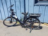 a bike that is parked next to a blue building