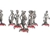 six silver figurines of women on wheels with bags on them
