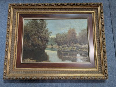 an oil painting of a river in a gold frame on a blue background