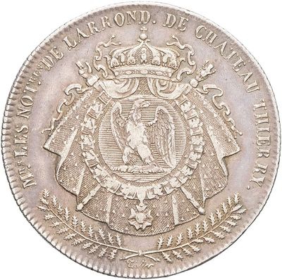 a close up of a silver coin with a crown on it