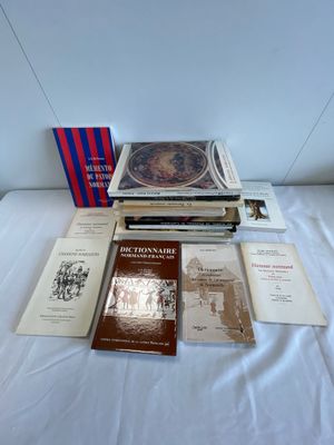 many books that are sitting on a bed together