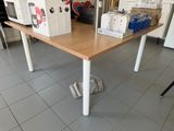 a table that has a microwave on it in the kitchen