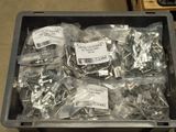 a lot of screws and nuts in a plastic container
