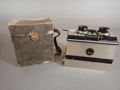 two old cameras sitting next to each other on a table