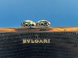 a close up of a black purse with two rings on top of it