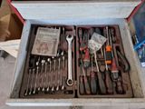 many tools in a tool box on the floor