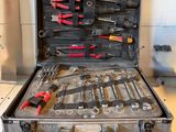 a suitcase with tools in it sitting on a table