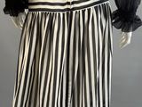 a black and white striped skirt with sheer sleeves on a mannequin mannequin mannequin mann
