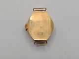 an image of a close up of a gold watch on a white surface