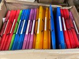 a box full of colorful folders sitting on the floor