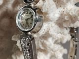 a close up of a wrist watch on a coral