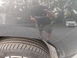 a reflection of a man taking a picture of himself in a car mirror