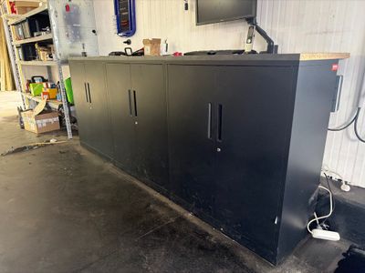 an image of a large black cabinet in a garage