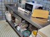 a kitchen with a sink, microwave, dishwasher, and other items on the counter