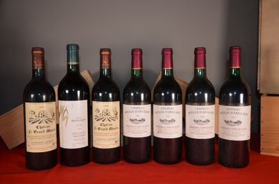 six bottles of wine are lined up on a red table