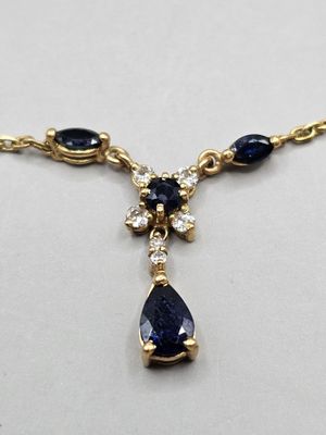 a close up of a necklace on a white surface