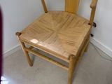 une chaise en bois qui se trouve dans un coin d'une pièce