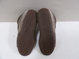 pair of brown slippers sitting on top of a white surface