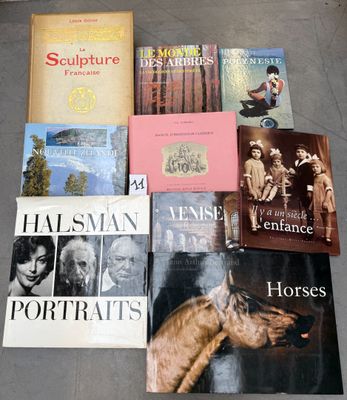 several books sitting on a floor next to each other on top of a table