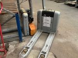 a forklift that is sitting on the ground in a warehouse