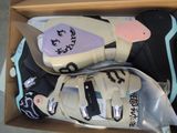 two pairs of shoes in a box on the floor