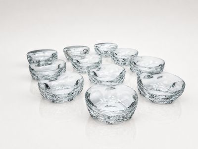 a group of glass bowls sitting on a white surface