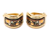 two gold rings with black and orange designs on them