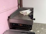 a toaster sitting next to a stove in a kitchen