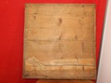 a picture of a piece of wood on a red wall
