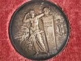 a close up of a coin on a red velvet surface