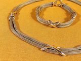 silver plated necklace and bracelet set on a yellow background