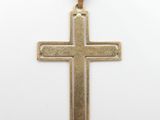 a gold cross pendant on a white background