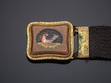 an image of a belt buckle with a picture of a bird on it