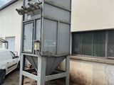 a truck parked next to a building with a machine on it