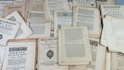 a pile of old books sitting on top of a table