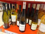 many bottles of wine on the shelf in the store
