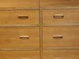 a close up of a wooden dresser on a white background