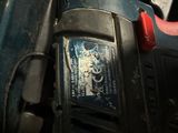a close up of a person ' s hand holding a cordless drill