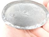 a person holding a metal object in their hand