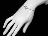 a white mannequin hand with a silver bracelet on it
