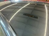 a parking meter on top of a car in a parking lot