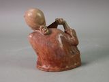 a small figurine of a woman holding a cell phone
