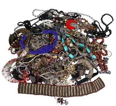 a pile of assorted jewelry on a white surface