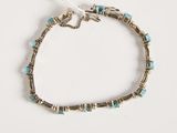a silver bracelet with turquoise stones and silver beads