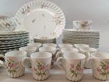 many cups and saucers that are sitting on a table