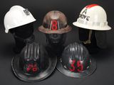 three hard hats with numbers on them sitting next to each other