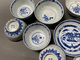 many blue and white plates and bowls on the table